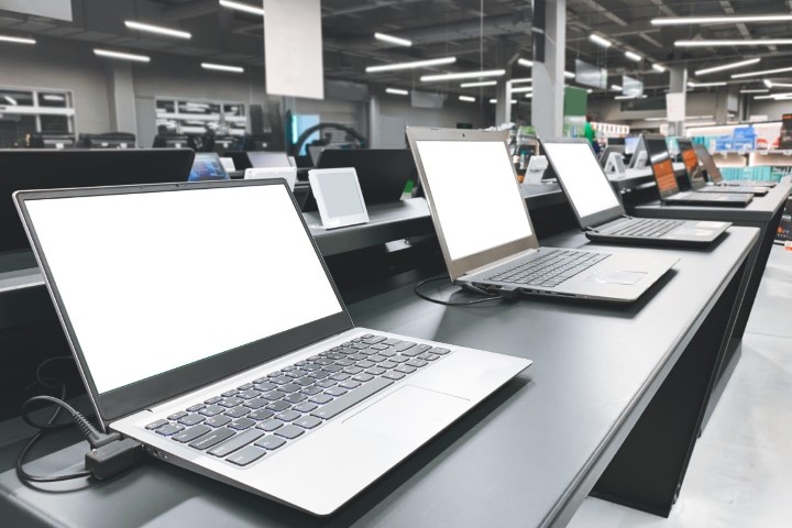 Laptops in a modern technology store. Department of computers in the electronics store. Choosing a laptop in the store